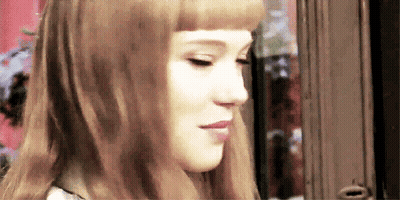 A Close Up Of A Woman 'S Face With Her Eyes Closed GIF