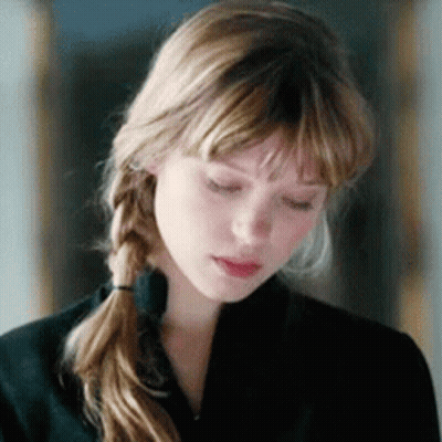 A Close Up Of A Woman 'S Face With Her Eyes Closed . GIF