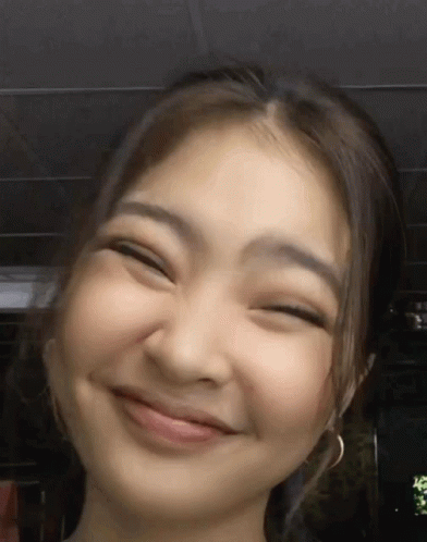 A Close Up Of A Woman 'S Face With Her Eyes Closed GIF