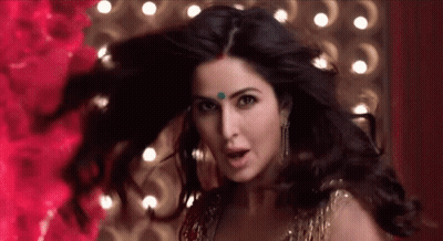 A Close Up Of A Woman 'S Face With Her Hair Flying In The Wind . GIF