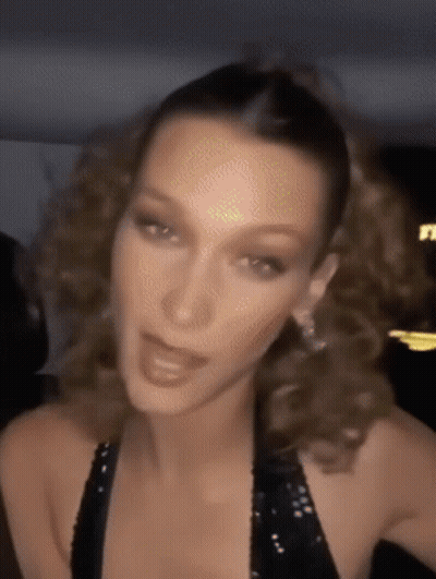 A Close Up Of A Woman 'S Face With Her Hair In A Ponytail . GIF