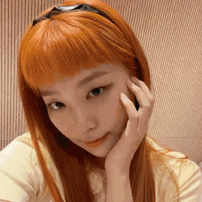 A Close Up Of A Woman 'S Face With Her Hand On Her Chin GIF