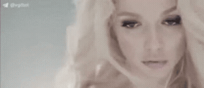 A Close Up Of A Woman 'S Face With Her Hand On Her Head . GIF