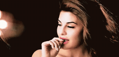 A Close Up Of A Woman 'S Face With Her Hand On Her Lips . GIF