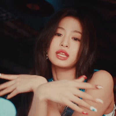 A Close Up Of A Woman 'S Face With Her Hands In The Air GIF