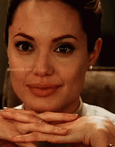 A Close Up Of A Woman 'S Face With Her Hands On Her Face GIF