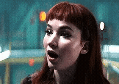 a close up of a woman 's face with her mouth open .