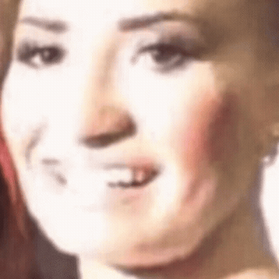 A Close Up Of A Woman 'S Face With Her Mouth Open And A White Background . GIF