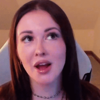 A Close Up Of A Woman 'S Face With Her Mouth Open And Her Eyes Closed . GIF