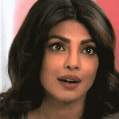 A Close Up Of A Woman 'S Face With Her Mouth Open And Her Eyes Closed . GIF