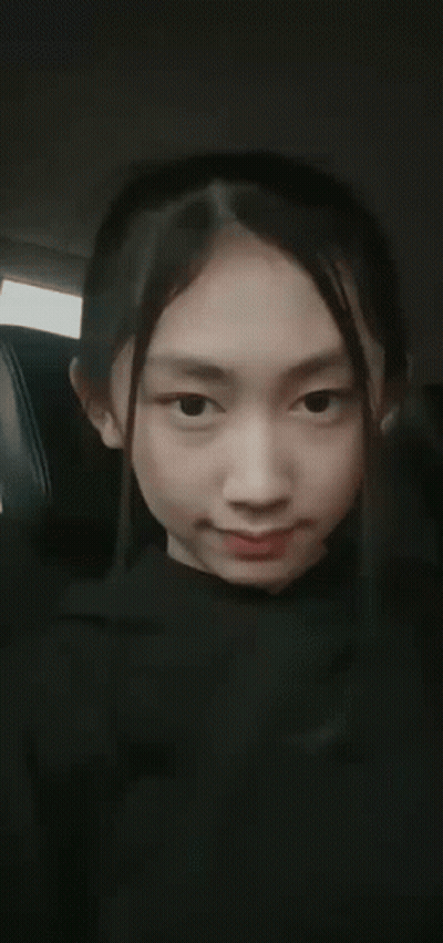 A Close Up Of A Woman 'S Face With Her Mouth Open And Her Teeth Visible . GIF