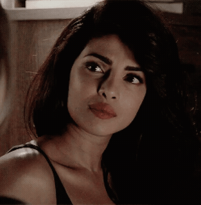 A Close Up Of A Woman 'S Face With Her Mouth Open GIF