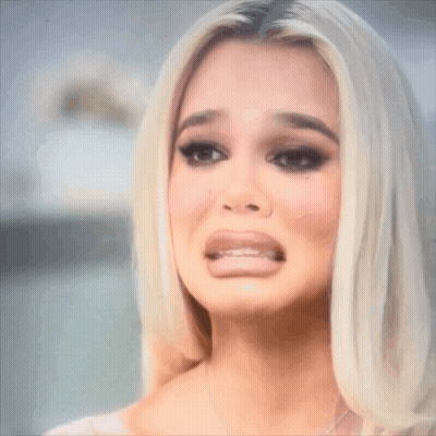 A Close Up Of A Woman 'S Face With Her Mouth Open GIF