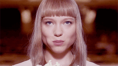 A Close Up Of A Woman 'S Face With Her Mouth Open GIF