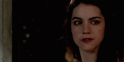 A Close Up Of A Woman 'S Face With Her Mouth Open GIF