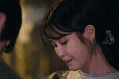 A Close Up Of A Woman 'S Face With Her Mouth Open GIF