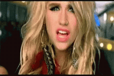 A Close Up Of A Woman 'S Face With Her Mouth Open . GIF