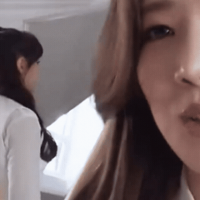 A Close Up Of A Woman 'S Face With Her Mouth Open GIF