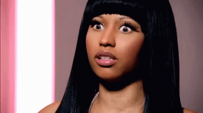 A Close Up Of A Woman 'S Face With Her Mouth Open GIF
