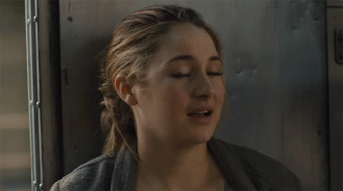 A Close Up Of A Woman 'S Face With Her Mouth Open GIF
