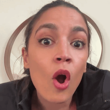 A Close Up Of A Woman 'S Face With Her Mouth Open GIF