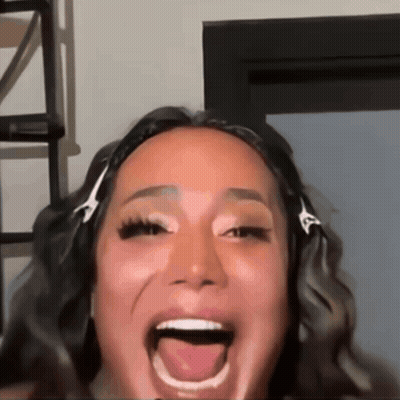 A Close Up Of A Woman 'S Face With Her Tongue Hanging Out GIF