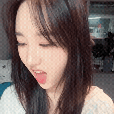 a close up of a woman 's face with her tongue hanging out .