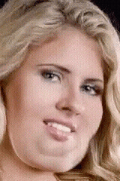 A Close Up Of A Woman 'S Face With Her Tongue Hanging Out GIF
