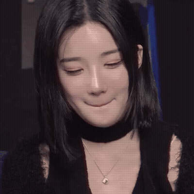 A Close Up Of A Woman 'S Face With Long Black Hair GIF