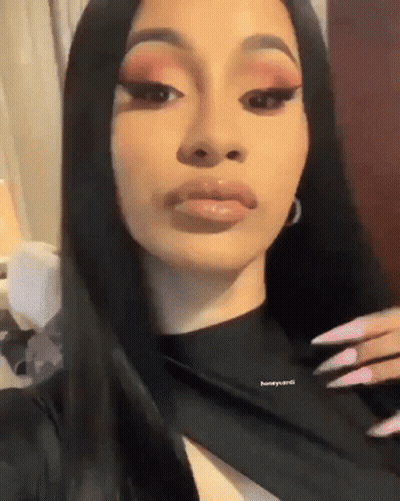 A Close Up Of A Woman 'S Face With Long Black Hair . GIF