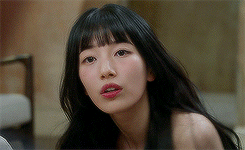 A Close Up Of A Woman 'S Face With Long Black Hair . GIF
