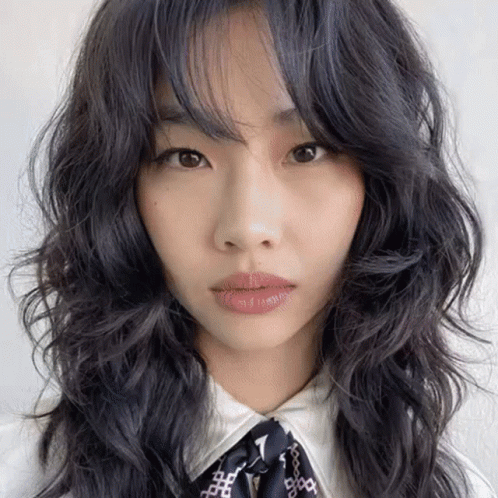 A Close Up Of A Woman 'S Face With Long Black Hair GIF