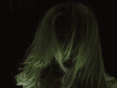 A Close Up Of A Woman 'S Face With Long Blonde Hair GIF