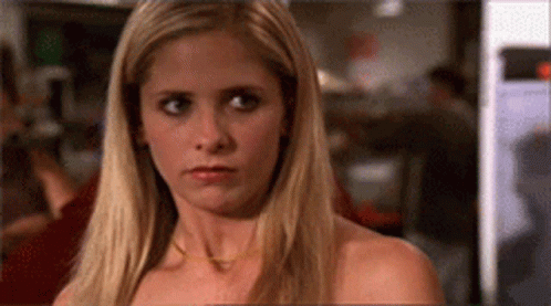 A Close Up Of A Woman 'S Face With Long Blonde Hair . GIF