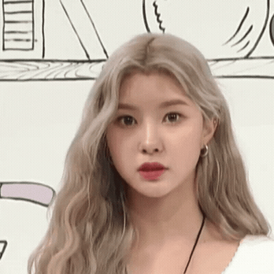 A Close Up Of A Woman 'S Face With Long Blonde Hair Against A White Background . GIF