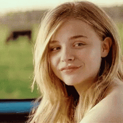 A Close Up Of A Woman 'S Face With Long Blonde Hair . GIF