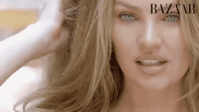 A Close Up Of A Woman 'S Face With Long Blonde Hair . GIF
