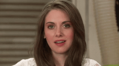 A Close Up Of A Woman 'S Face With Long Brown Hair And A White Shirt . GIF