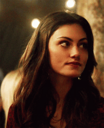 A Close Up Of A Woman 'S Face With Long Dark Hair GIF