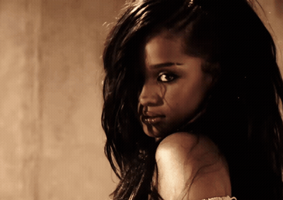 A Close Up Of A Woman 'S Face With Long Dark Hair GIF