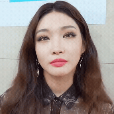 A Close Up Of A Woman 'S Face With Long Hair GIF