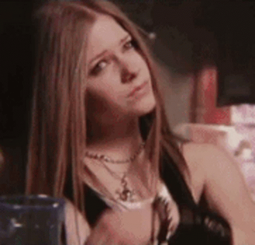 A Close Up Of A Woman 'S Face With Long Hair . GIF
