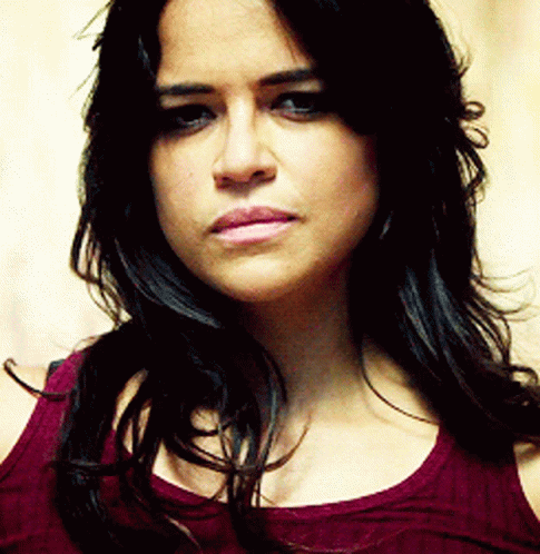 A Close Up Of A Woman 'S Face With Long Hair GIF