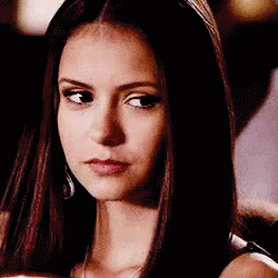 A Close Up Of A Woman 'S Face With Long Hair And A Serious Look On Her Face . GIF