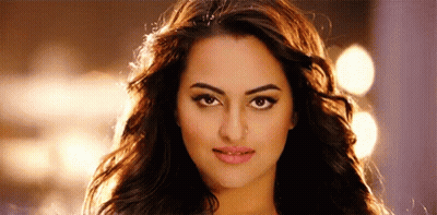 A Close Up Of A Woman 'S Face With Long Hair And A Serious Look On Her Face . GIF