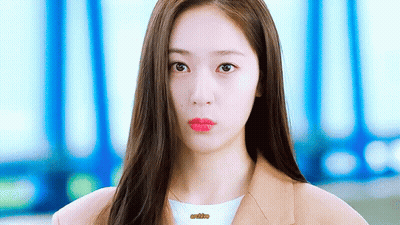 A Close Up Of A Woman 'S Face With Long Hair And Red Lips GIF