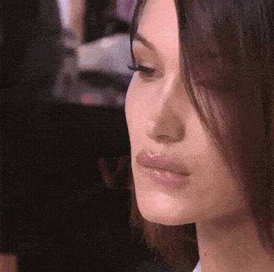 A Close Up Of A Woman 'S Face With Long Hair GIF