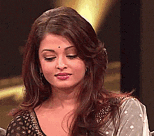 A Close Up Of A Woman 'S Face With Long Hair GIF