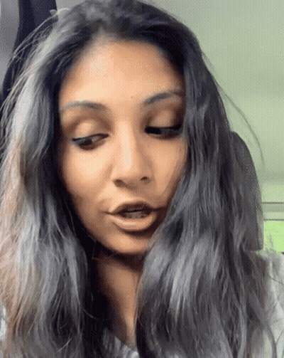 A Close Up Of A Woman 'S Face With Long Hair GIF