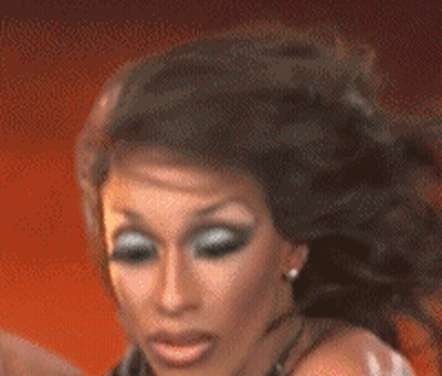 A Close Up Of A Woman 'S Face With Long Hair GIF